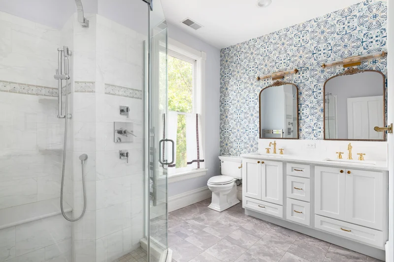 Custom bathroom renovation with elegant patterned wallpaper and a double vanity. Custom bathroom renovation with elegant patterned wallpaper and a double vanity.