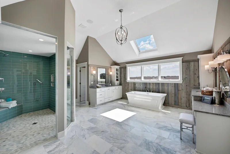 Luxury master bathroom with marble tile and freestanding soaking tub. Luxury master bathroom with marble tile and freestanding soaking tub.