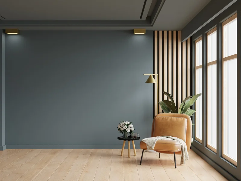 Cozy interior room with dark grey painted wall and leather chair. Cozy interior room with dark grey painted wall and leather chair.